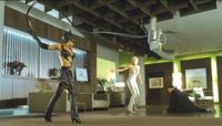 A woman in a black leather catsuit holds a long whip in a contemporary living room near a person on the floor.