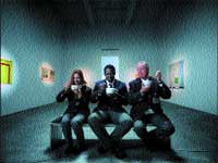 Three people sit on a bench in a gallery, each holding and drinking from a white cup.