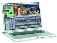 A silver laptop open, showing a video editing interface with timelines and video clips on the screen.