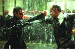 Two men in dark suits stand facing each other amidst falling water or debris.