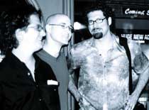 Three men standing side by side in a black and white photo.