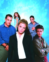 Five people of various ages posing against a bright blue textured background.