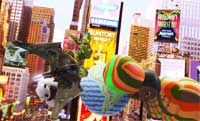 A small green toy soldier figure positioned in front of a miniature city model with skyscrapers and signs.