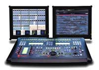A video production control console with two monitors displaying technical interfaces.