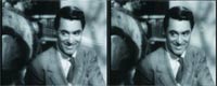 Two identical black and white portraits of a smiling man wearing a suit and tie.