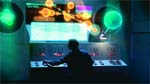 Silhouette of a person operating a glowing control panel with digital light overlays.