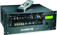 A black Christie rack-mounted electronic device with various ports and a remote control on top.