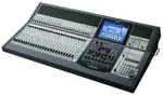 A professional digital audio mixing console with numerous sliders, knobs, and a central digital display screen.