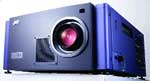 A dark blue digital projector with a large central lens and side controls.