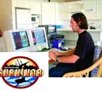 A man sits in a room looking at two computer monitors next to a Survivor logo.