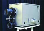 A large silver rectangular scientific device with multiple black lenses mounted on the front.