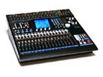 A black digital audio mixing console with various knobs, sliders, and a central blue display screen.
