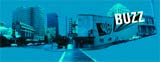 Blue-tinted cityscape featuring urban buildings and the word BUZZ in bold white letters.