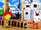 A yellow puppet and a red toy dog stand near a line of black dominoes and white block structures.