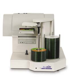 A white Macelite Disc Maker machine with stacks of green discs and a disc pressing mechanism.