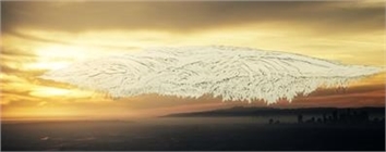 A massive, textured white cloud shaped like a wing floats over a dark horizon during a golden sunset.
