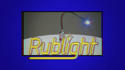 A screen displaying the word Rublight in yellow script with a small desk lamp above it.