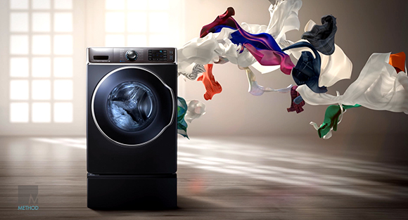 A black front-loading washing machine with various colorful pieces of clothing swirling in the air around it.