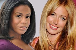 A Black woman with dark hair and a blonde woman smiling against a light background.