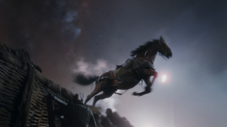 A dark horse mid-leap against a smoky, dimly lit sky.